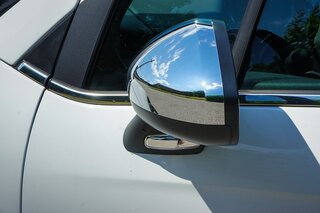 side view of silver car and wing mirror
