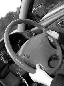 Hands on a car steering wheel