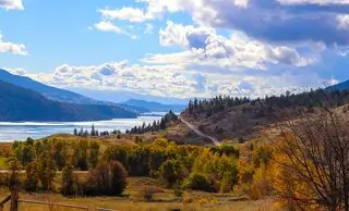 view acrosss forested hills to a lake