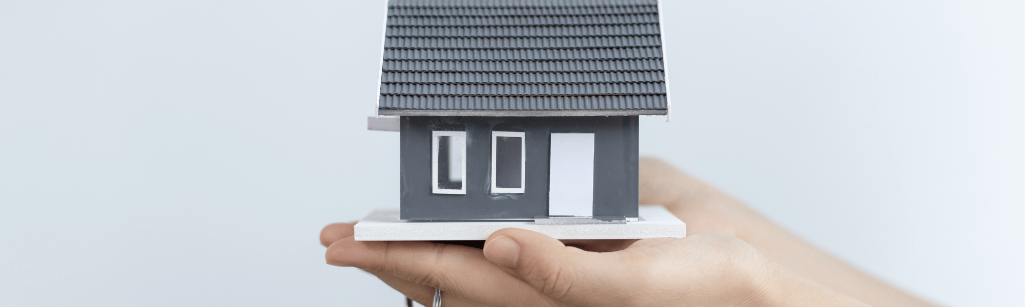 hand insuring a house is protected