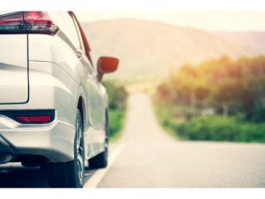right side of silver car seen from the back, looking into the distance down a road