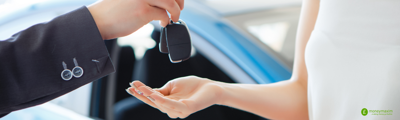 woman accepting keys to a new car