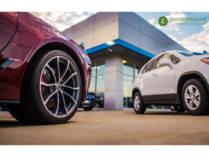 two cars parked outside a dealership