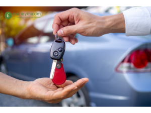 handing over car keys with car in background